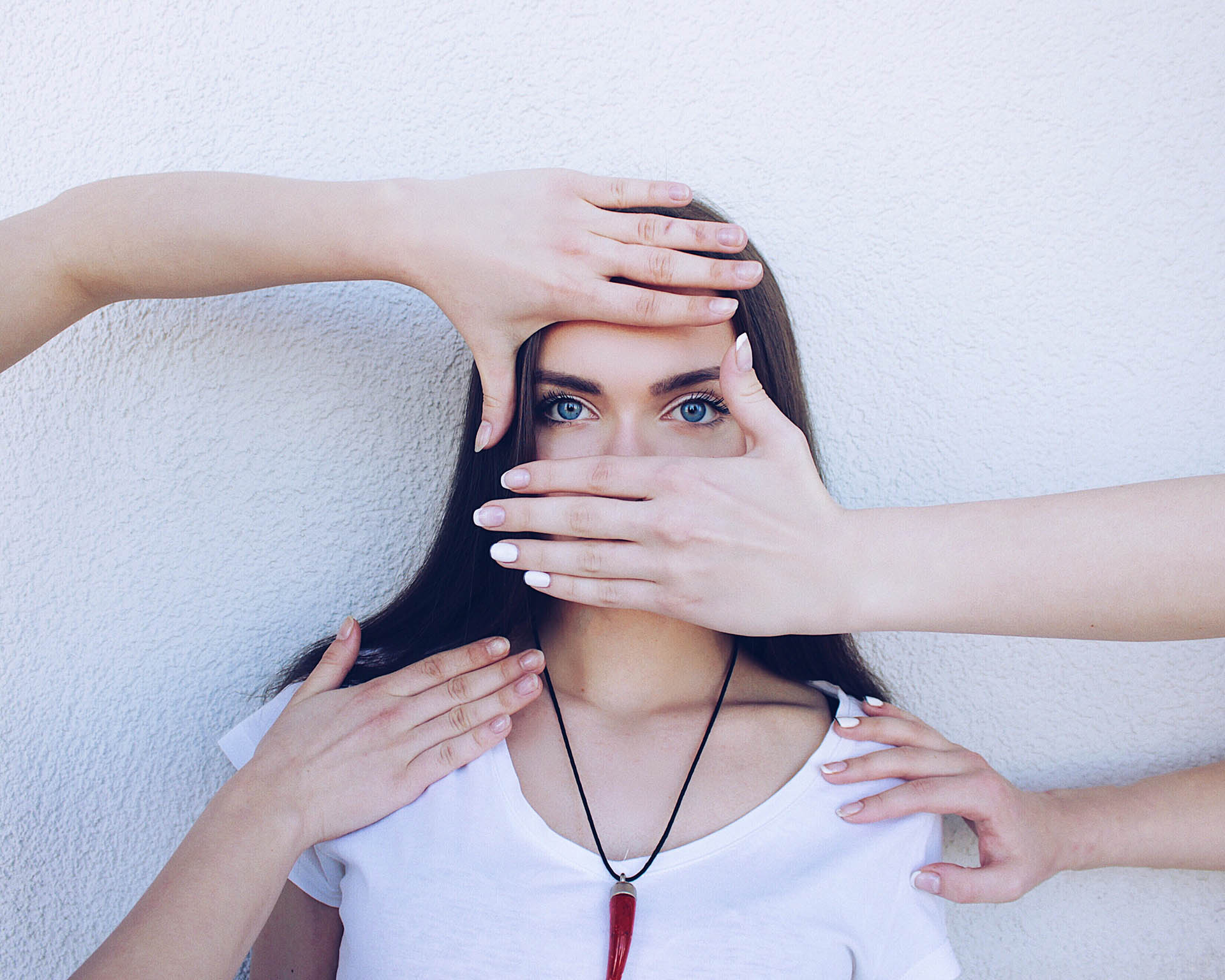 People covering the face of a woman